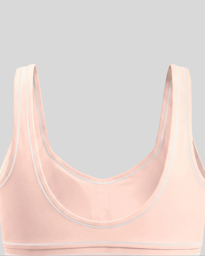 Close-up of the scoop back and contrast piping on the TrackLine Outline Sports Bra in Light Pink