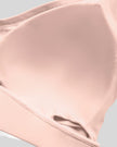 Interior removable chest padding detail of the TrackLine Outline Sports Bra in Light Pink