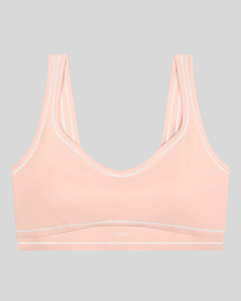 TrackLine Outline Sports Bra in Light Pink front view featuring contrast piping and a supportive fit