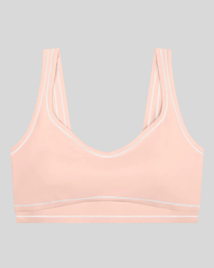TrackLine Outline Sports Bra in Light Pink front view featuring contrast piping and a supportive fit
