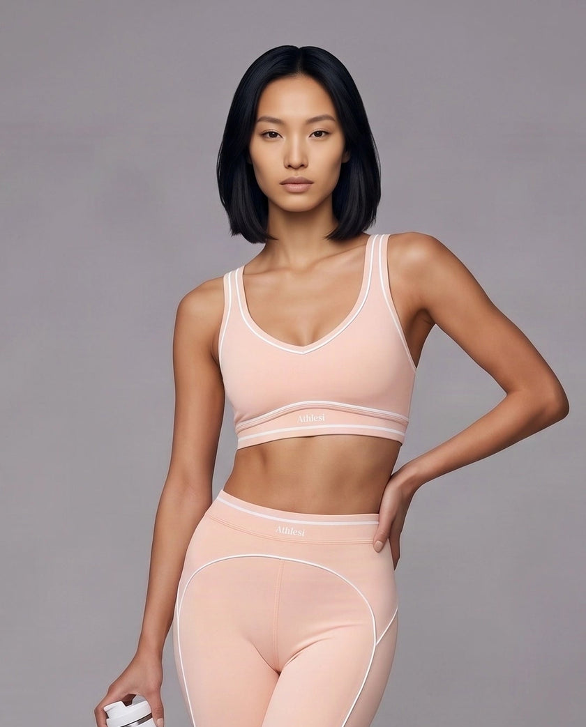 Model wearing the TrackLine Outline Sports Bra in Light Pink viewed from the front