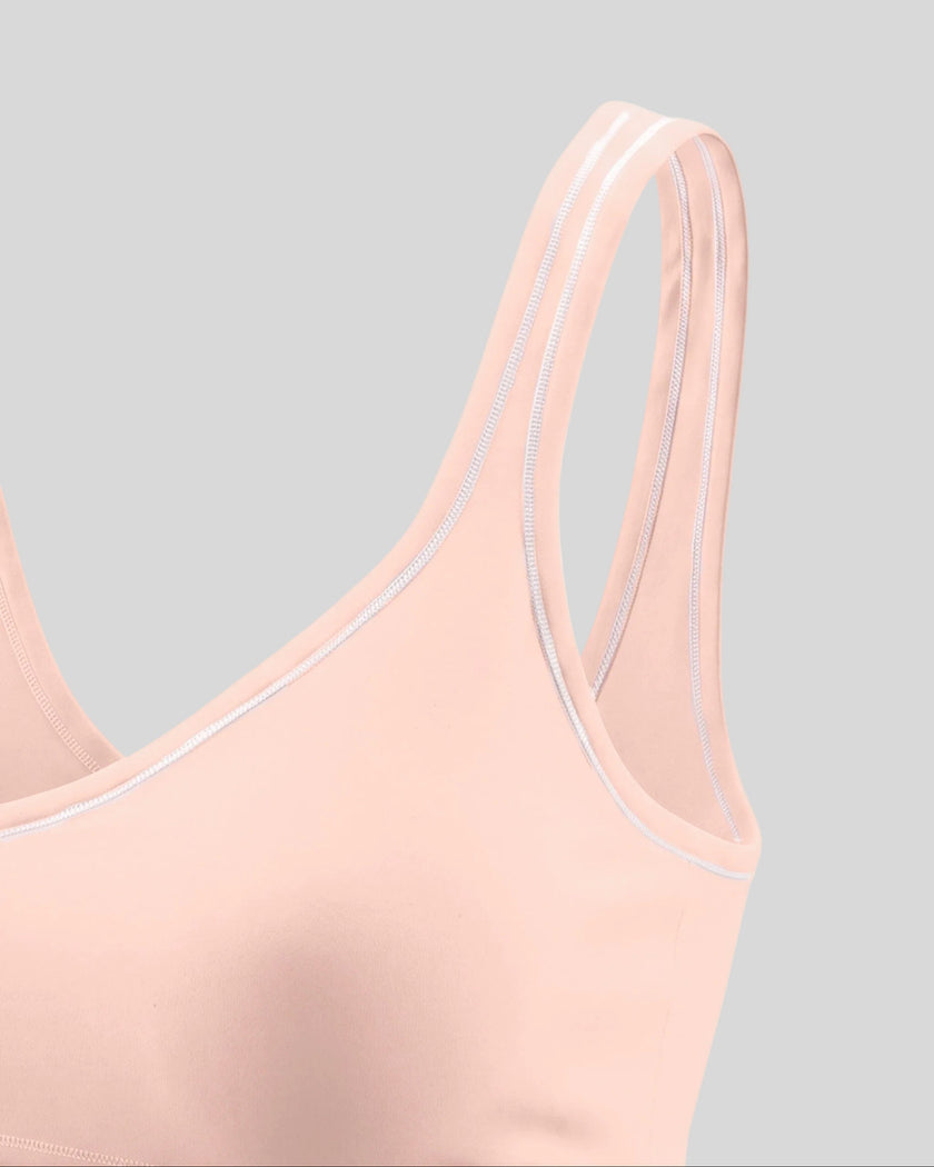 Side angle close-up of the TrackLine Outline Sports Bra in Light Pink highlighting its supportive silhouette
