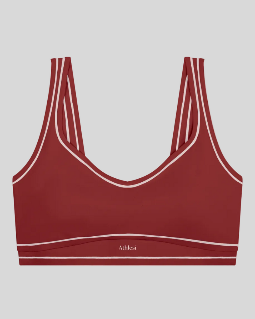 TrackLine Outline Sports Bra in Red front view featuring contrast piping and a supportive fit