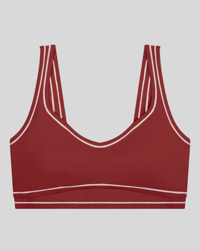 TrackLine Outline Sports Bra in Red front view featuring contrast piping and a supportive fit