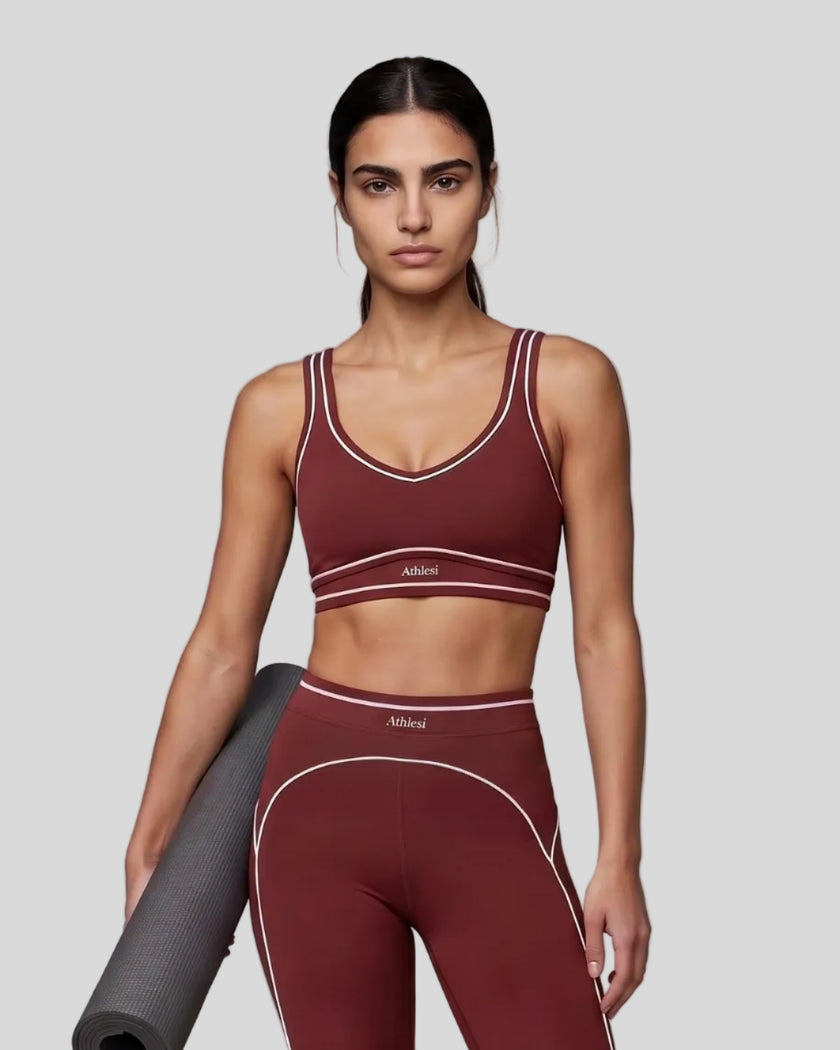 Model wearing the TrackLine Outline Sports Bra in Red viewed from the front