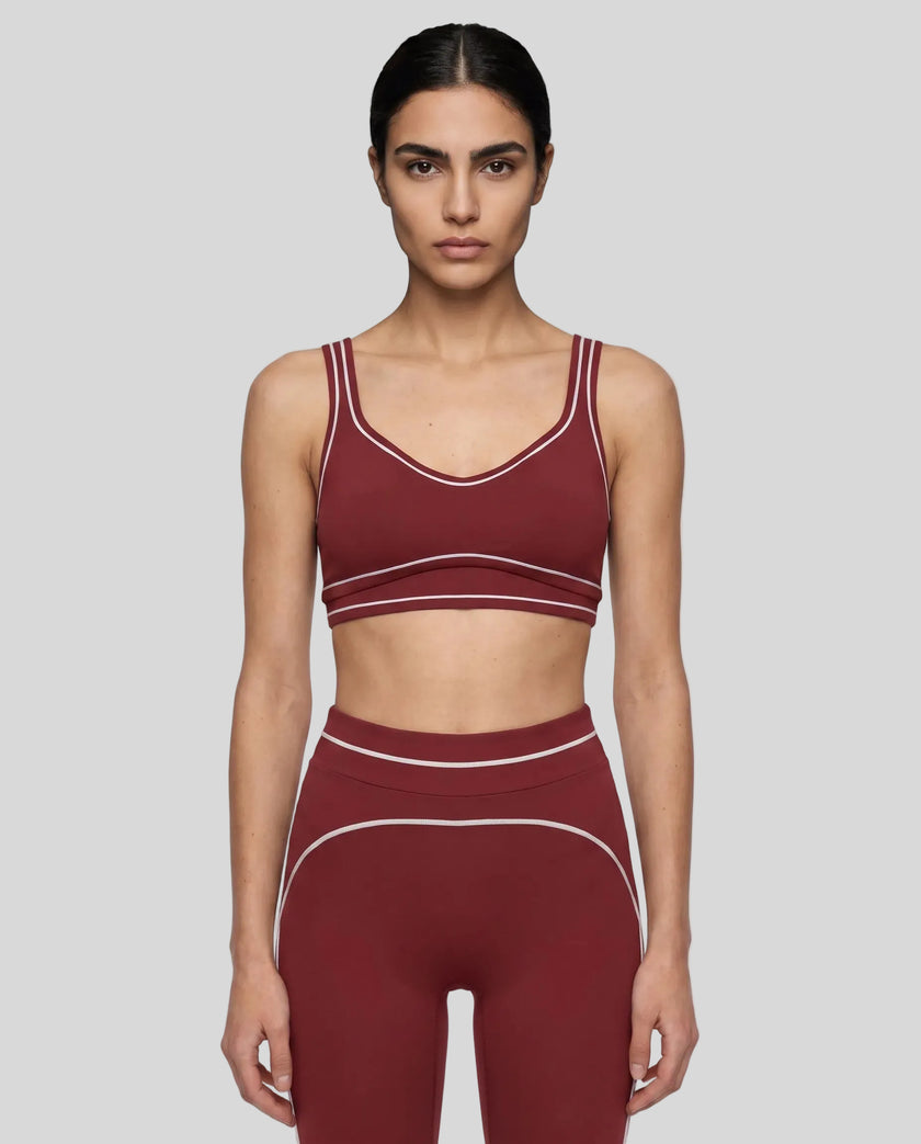 Model wearing the TrackLine Outline Sports Bra in Red viewed from the front