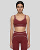Model wearing the TrackLine Outline Sports Bra in Red viewed from the front