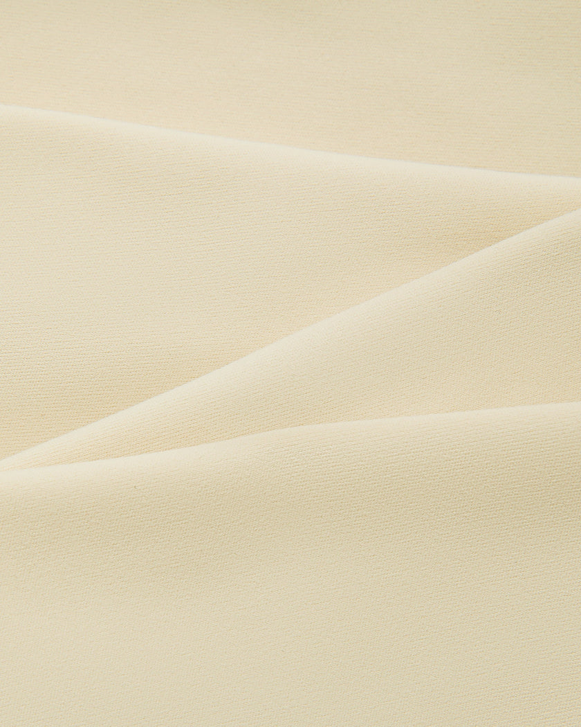 Close-up of the smooth stretch performance fabric used on the TrackLine Outline Tank Top in Light Apricot