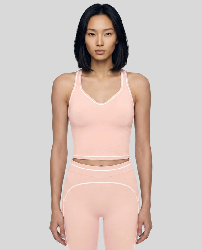 Model wearing the TrackLine Outline Tank Top in Light Pink viewed from the front