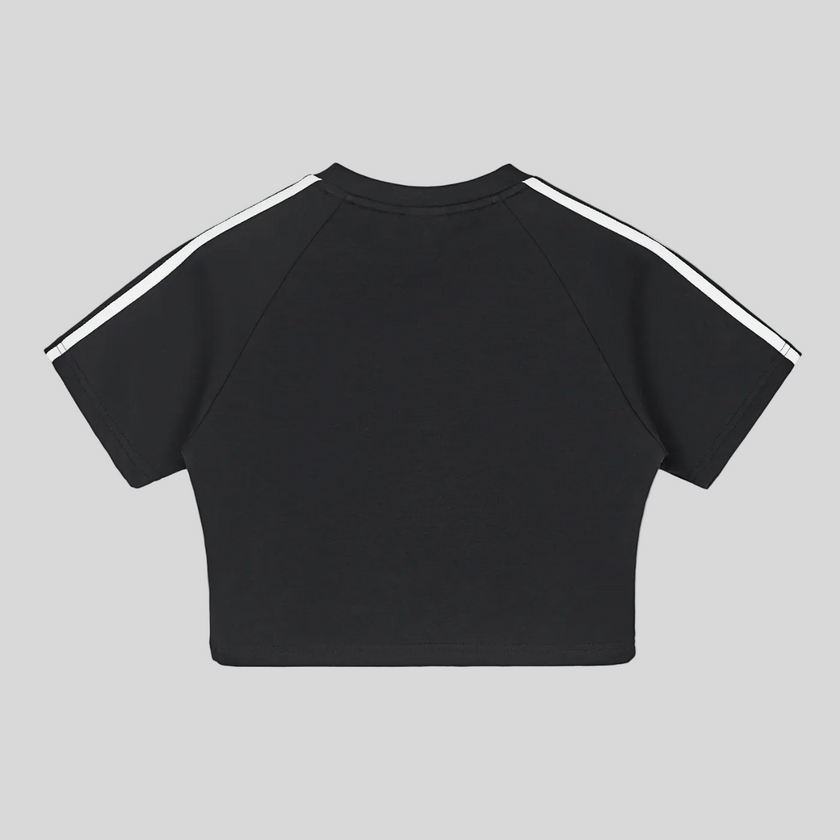 Back view flatlay of the Athlesi TrackLine Performance Crop Tee in black with minimalist athletic detailing