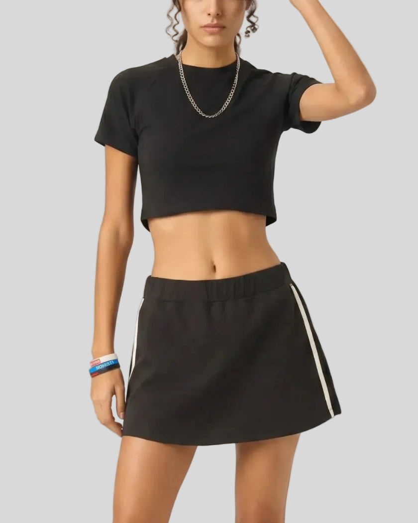 Angled view of the Athlesi TrackLine Performance Crop Tee in black with minimalist sport-inspired styling