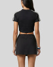 Mid body back view of the Athlesi TrackLine Performance Crop Tee in black
