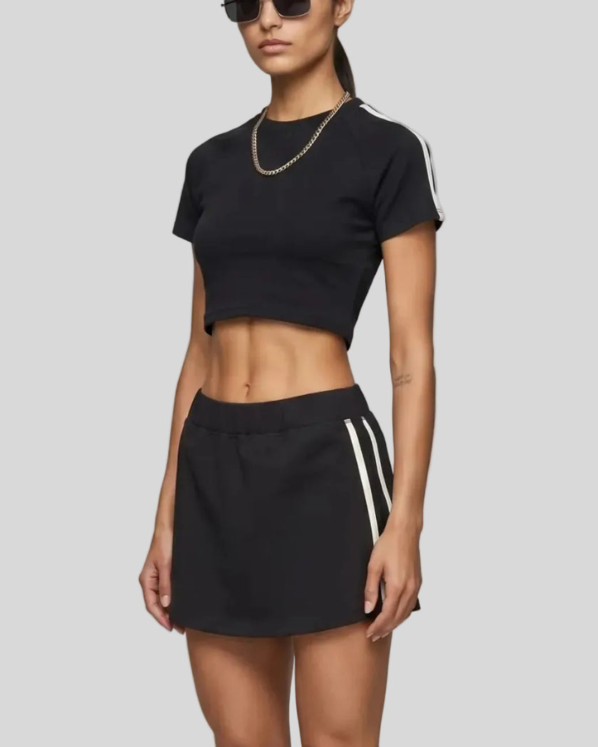 Angled front view of the Athlesi TrackLine Performance Crop Tee in black with contrast athletic taping