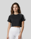 Upper body front view of a woman wearing the Athlesi TrackLine Performance Crop Tee in black
