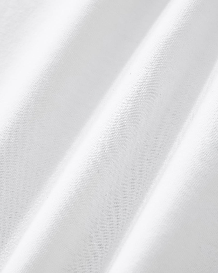 Closeup of the soft stretch performance fabric texture on the Athlesi TrackLine Performance Crop Tee in white