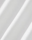 Closeup of the stretch performance fabric texture on the Athlesi TrackLine Performance Skort in white