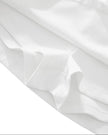 Hem detail closeup of the Athlesi TrackLine Performance Skort in white