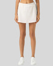 Lower body front view of the Athlesi TrackLine Performance Skort in white