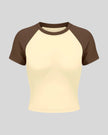 TrackLine Raglan Baby Tee in Apricot with Coffee front view with contrast short sleeves and crew neckline