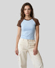 Woman wearing the TrackLine Raglan Baby Tee in Sky Blue and Coffee from the front showing its fitted cropped silhouette