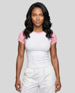 Woman wearing the TrackLine Raglan Baby Tee in White with Pink from the front showing its fitted cropped silhouette