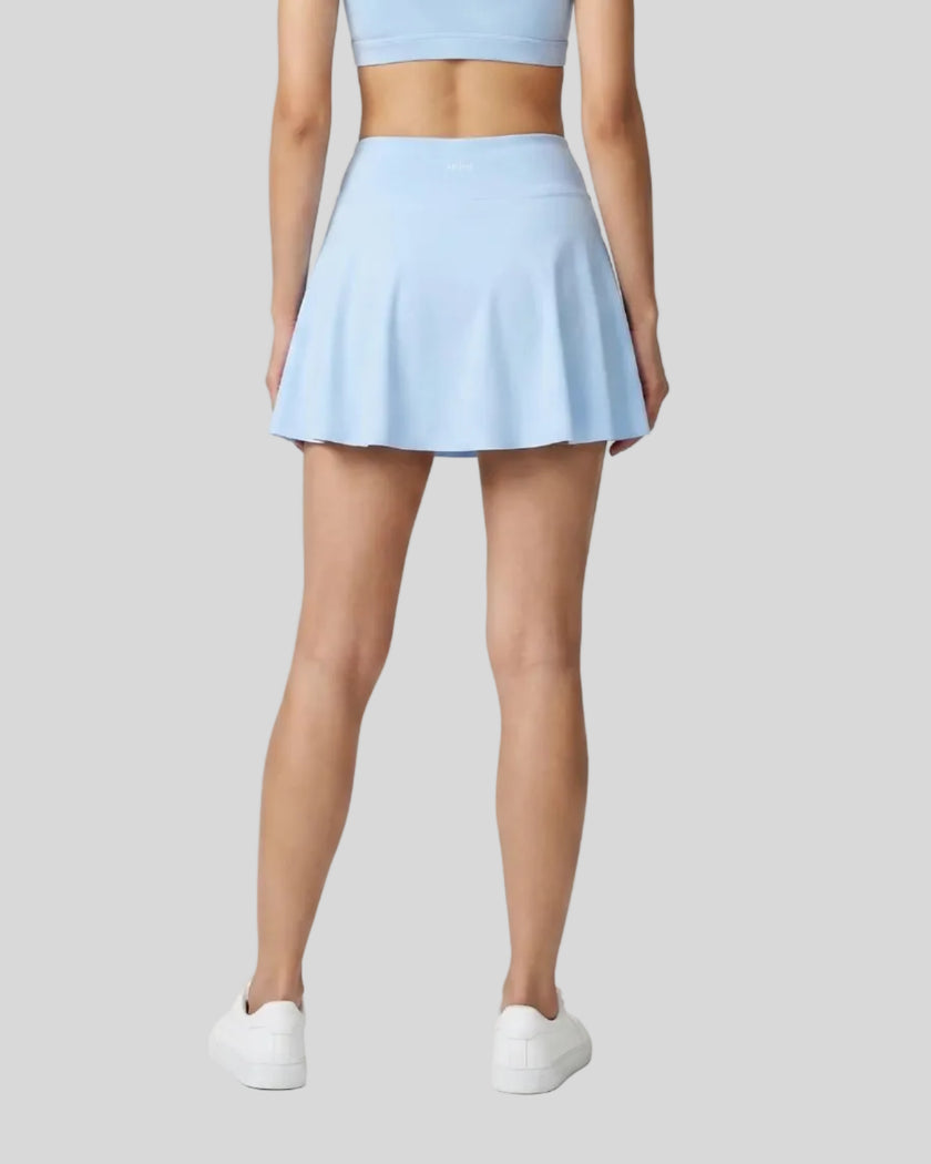 Back view of the TrackLine Rally A-Line Slit Skirt in sky blue on model