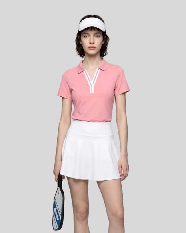Model wearing the pink Athlesi TrackLine Rally Polo Shirt with white contrast neckline, front view