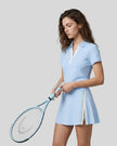 Model wearing the sky blue Athlesi TrackLine Rally Polo Shirt with white contrast neckline, front view