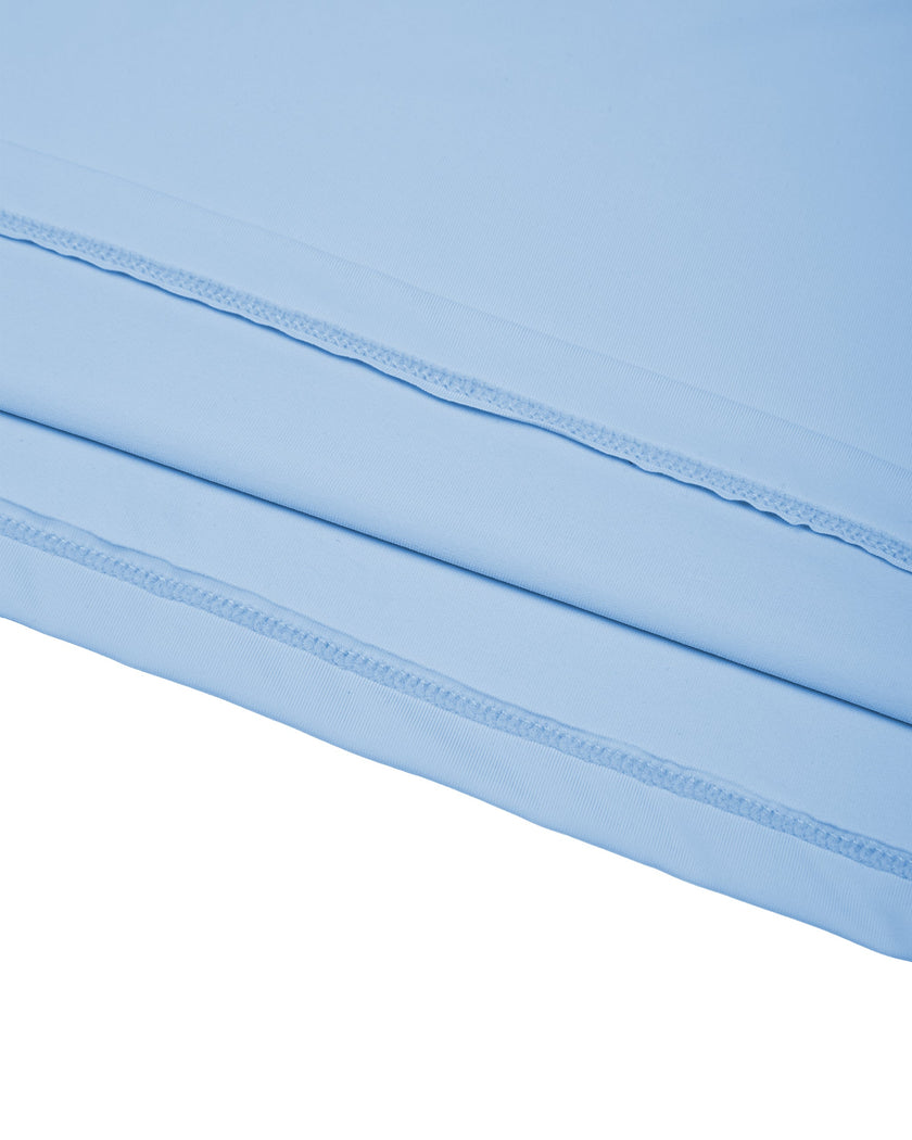 Close-up of the straight hem on the sky blue Athlesi TrackLine Rally Polo Shirt