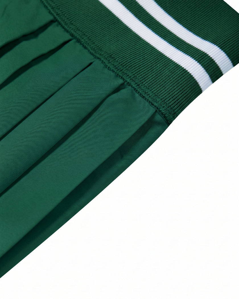 Side waistband closeup of TrackLine Rally Skirt in blackish green showing ribbed athletic finish