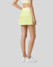 Angled back view of TrackLine Rally Skirt in light green styled for tennis, pickleball, and athleisure wear