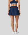 Back view of TrackLine Rally Skirt in navy blue featuring full pleated design
