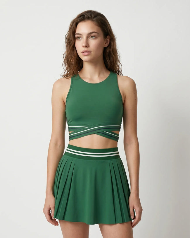Woman wearing TrackLine Rally Sports Bra in blackish green front view with retro athletic styling