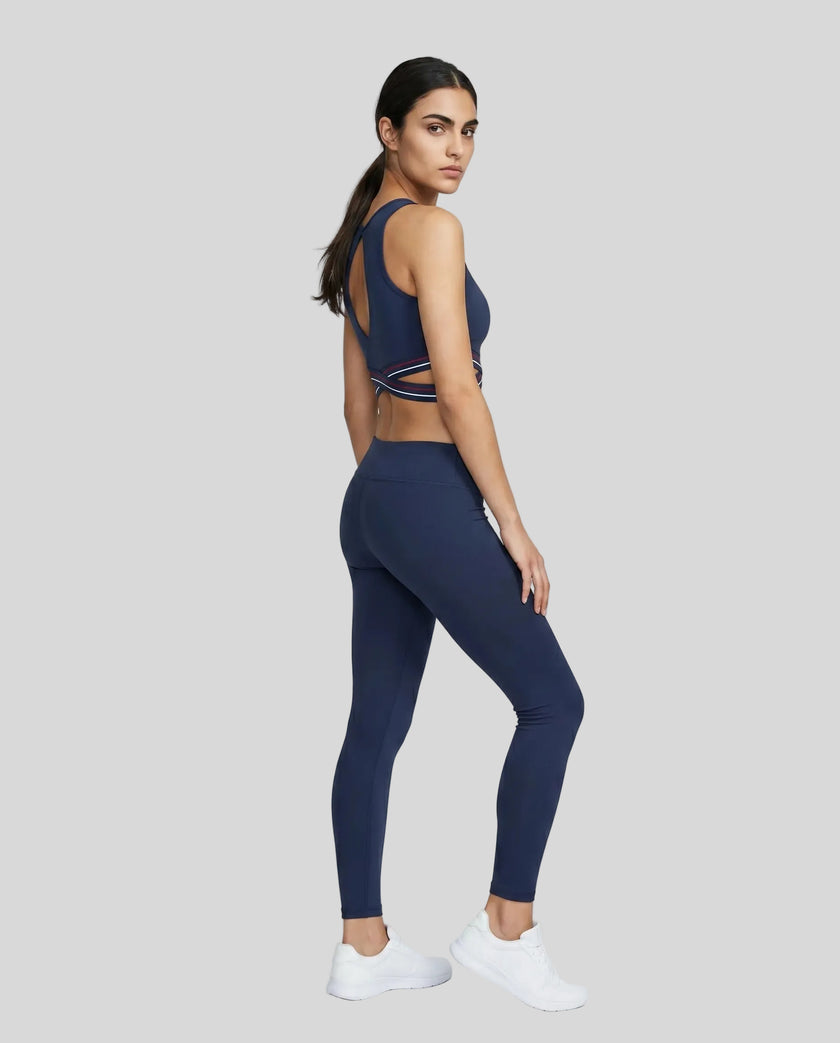 Full body angled back view of TrackLine Rally Sports Bra in navy blue with criss-cross athletic styling