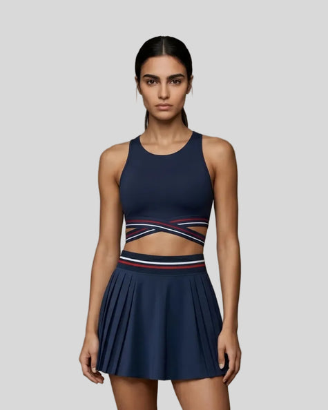 Woman wearing TrackLine Rally Sports Bra in navy blue front view with retro athletic styling