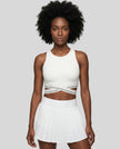 Woman wearing TrackLine Rally Sports Bra in white front view with retro athletic styling