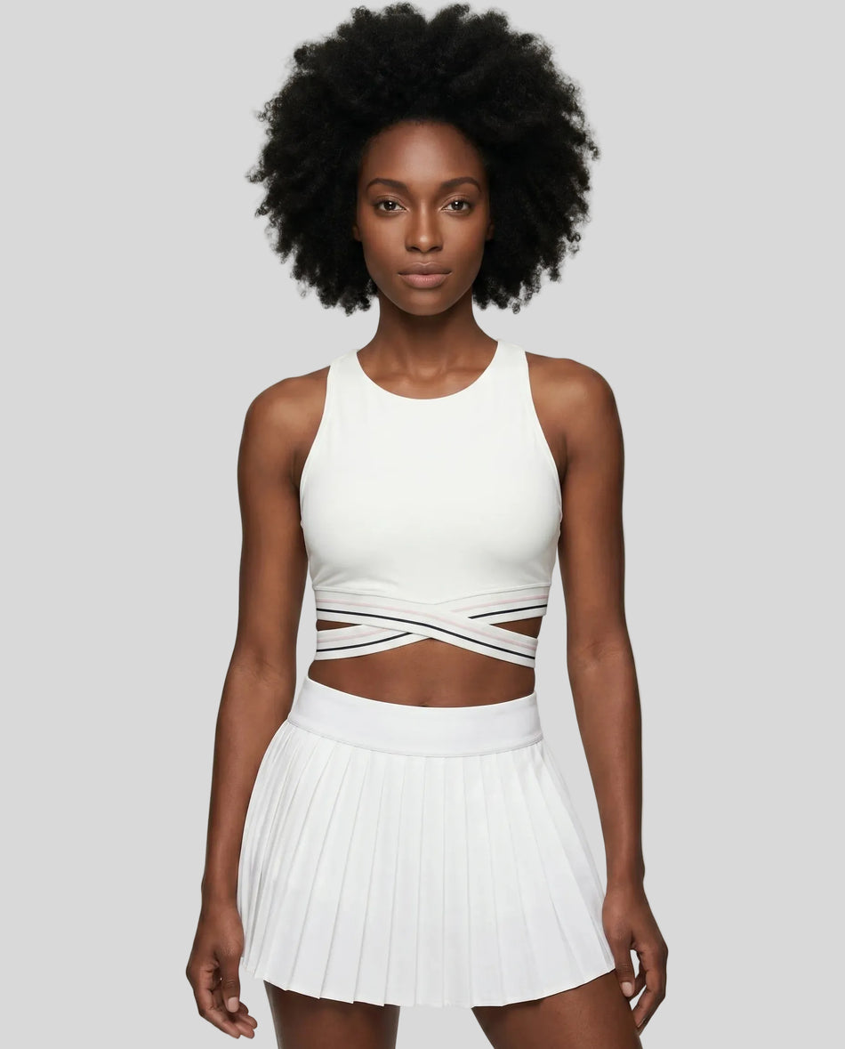 Woman wearing TrackLine Rally Sports Bra in white front view with retro athletic styling