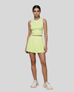 Front view of Model wearing the TrackLine Rally Tank in Light Green with White, paired with Trackline Rally Skirt in Light Green.