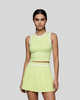 A model wearing a Light Green TrackLine Rally Tank top with white trim and a Light Green TrackLine Rally Skirt with white trim, set against a solid gray background.