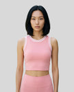 Model wearing the TrackLine Rally Tank in Rose Pink with White, front view.