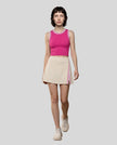 Front view of Model wearing the TrackLine Rally Tank in Rose Red with White, paired with Trackline Rally Slit Skirt in Light Apricot.