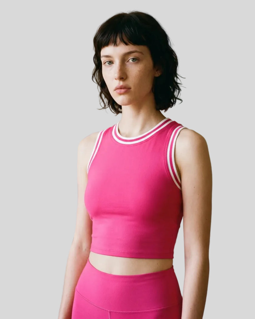 Model wearing the TrackLine Rally Tank in Rose Red with White, front view.