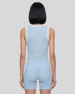 Model wearing the TrackLine Rally Tank in Sky Blue with White, back view.