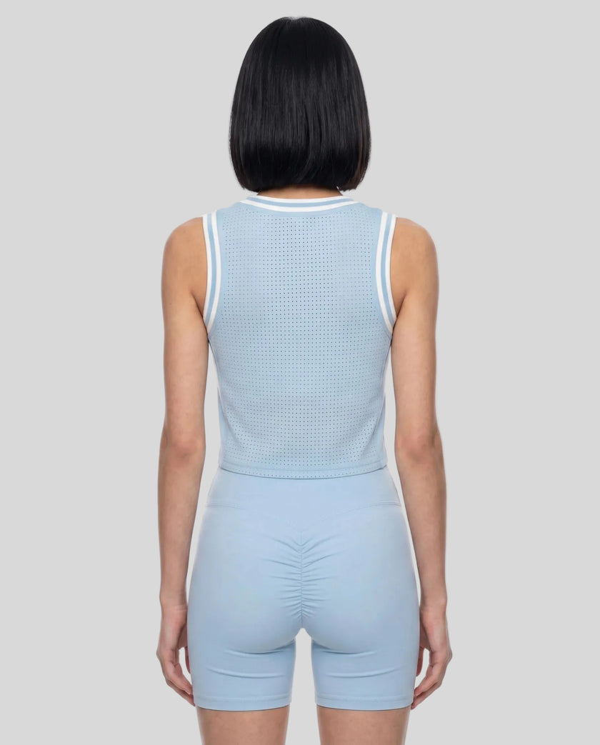 Model wearing the TrackLine Rally Tank in Sky Blue with White, back view.