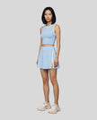 Front view of Model wearing the TrackLine Rally Tank in Sky Blue with White, paired with Trackline Rally Skirt in Sky Blue.