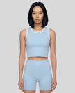 Model wearing the TrackLine Rally Tank in Sky Blue with White, front view.