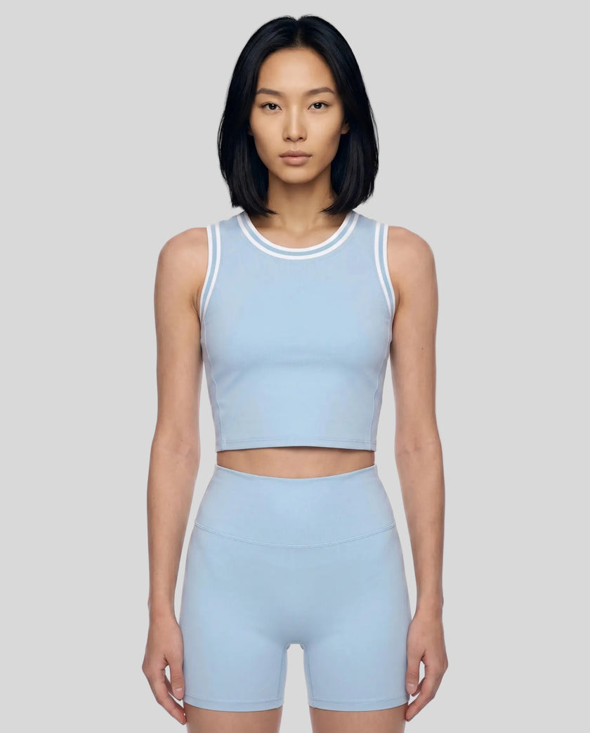 Model wearing the TrackLine Rally Tank in Sky Blue with White, front view.