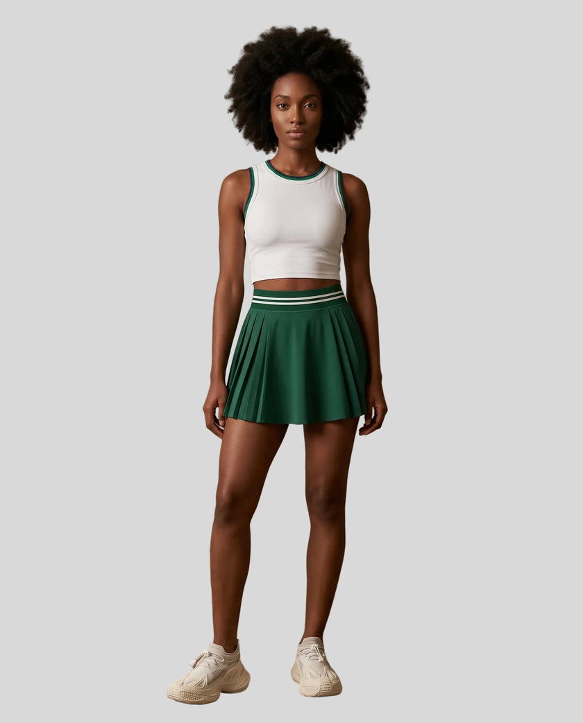 Front view of Model wearing the TrackLine Rally Tank in White with Green, paired with Trackline Rally Skirt in Blackish Green.