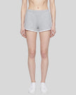 Model wearing the Athlesi TrackLine Retro Shorts in flower gray and white front view