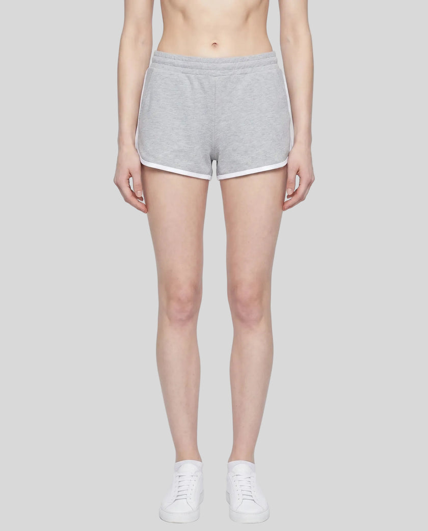 Model wearing the Athlesi TrackLine Retro Shorts in flower gray and white front view